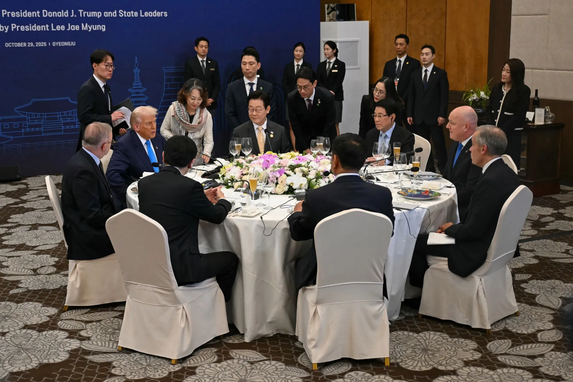 Donald Trump, second from left, seated across from Mark Carney at the special dinner in Gyeongju.