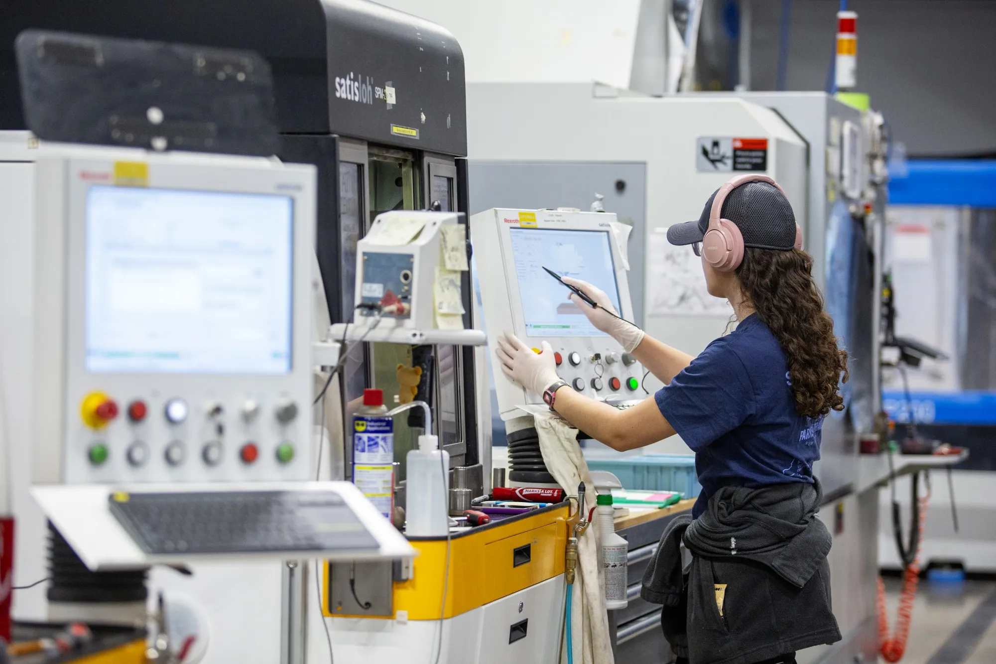 An employee works on the production floor of a precision optics manufacturing facility in Ontario, New York.