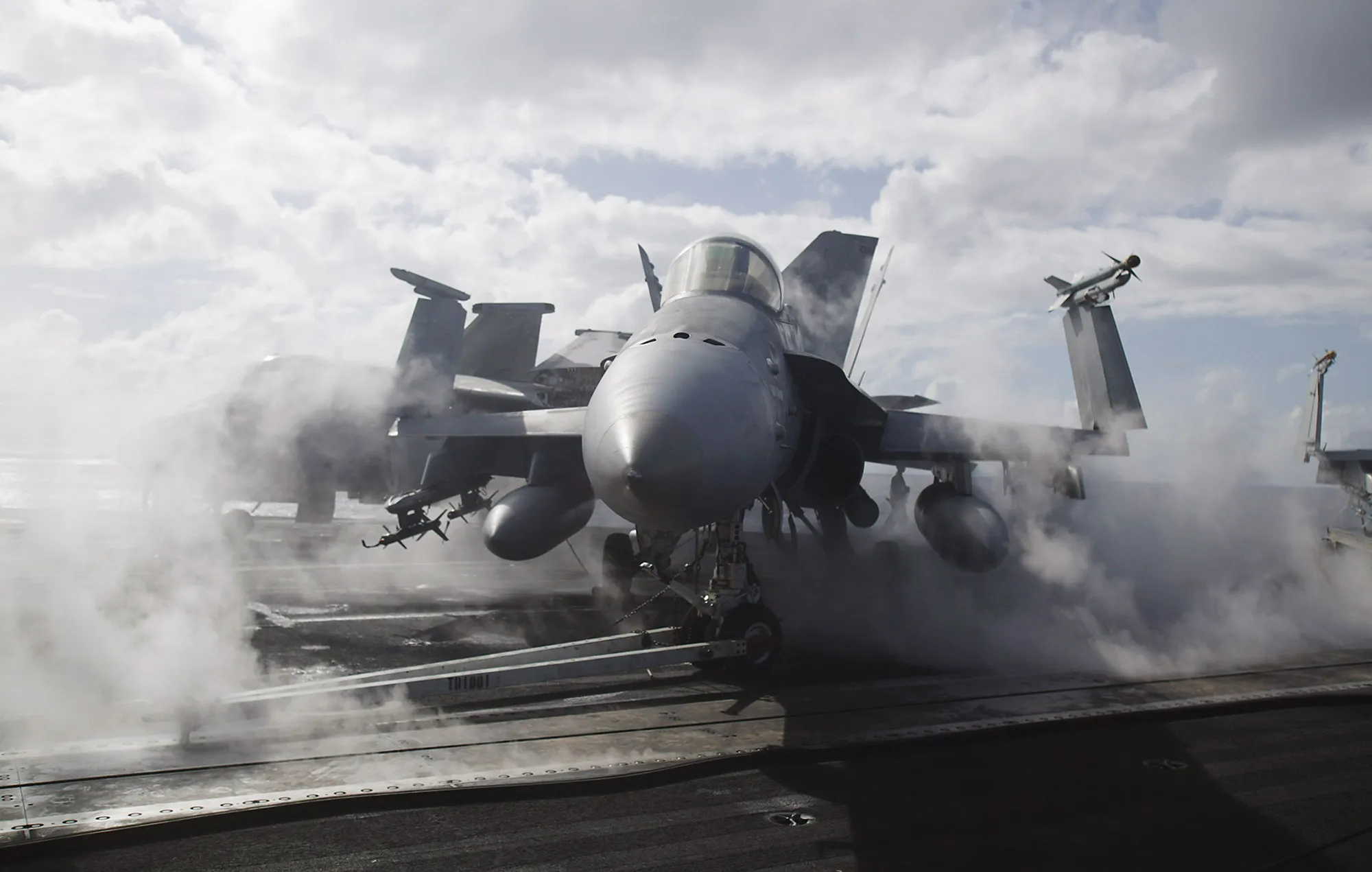 A fighter jet is surrounded by steam on the deck of the USS Johh C. Stennis&nbsp;in waters near Hawaii.&nbsp;
