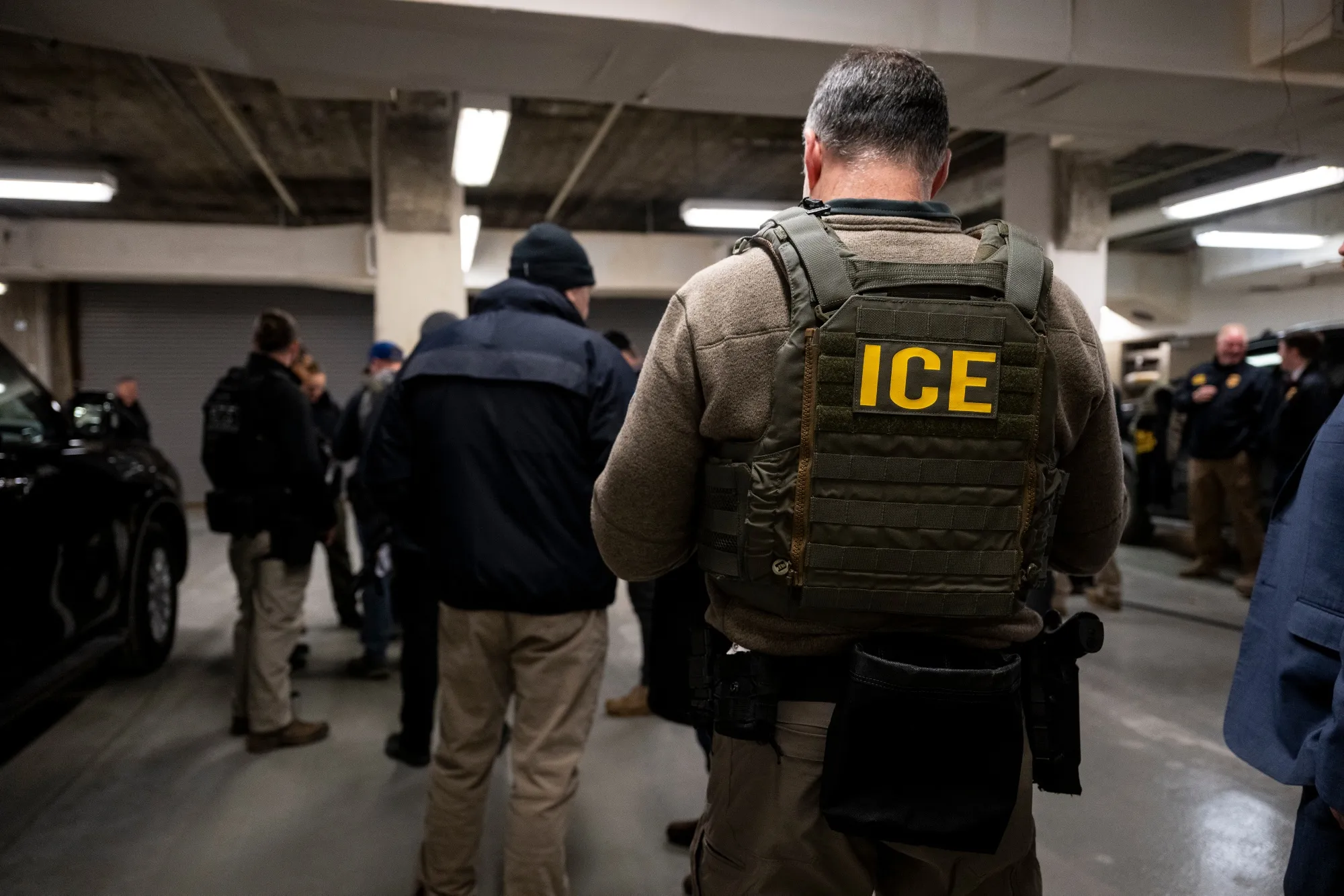 ICE&nbsp;agents, along with other federal law enforcement agencies, meet ahead of a raid in Chicago on Jan. 26.