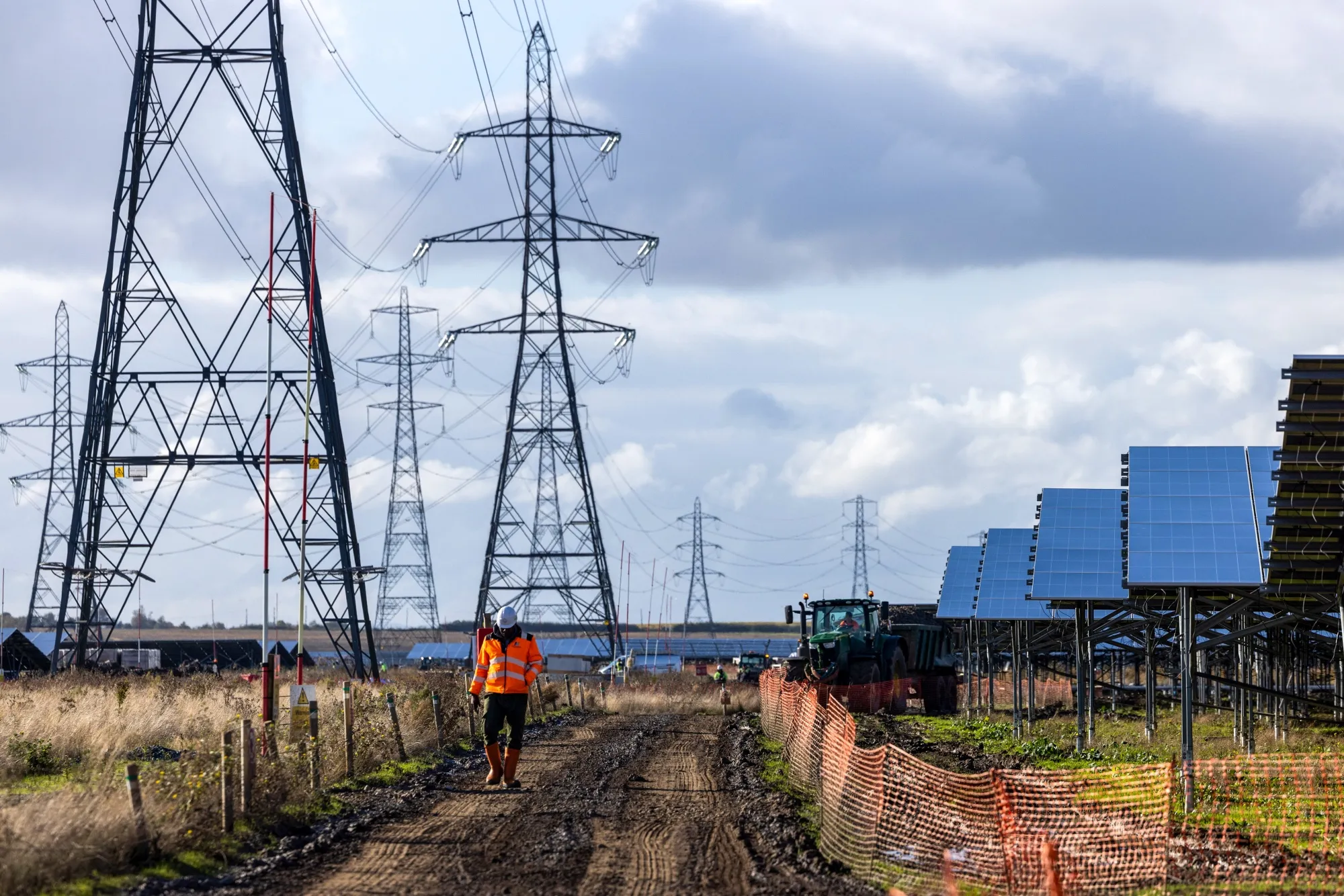 Electricity pylons and solar panels at Cleve Hill Solar Park near Faversham, UK.