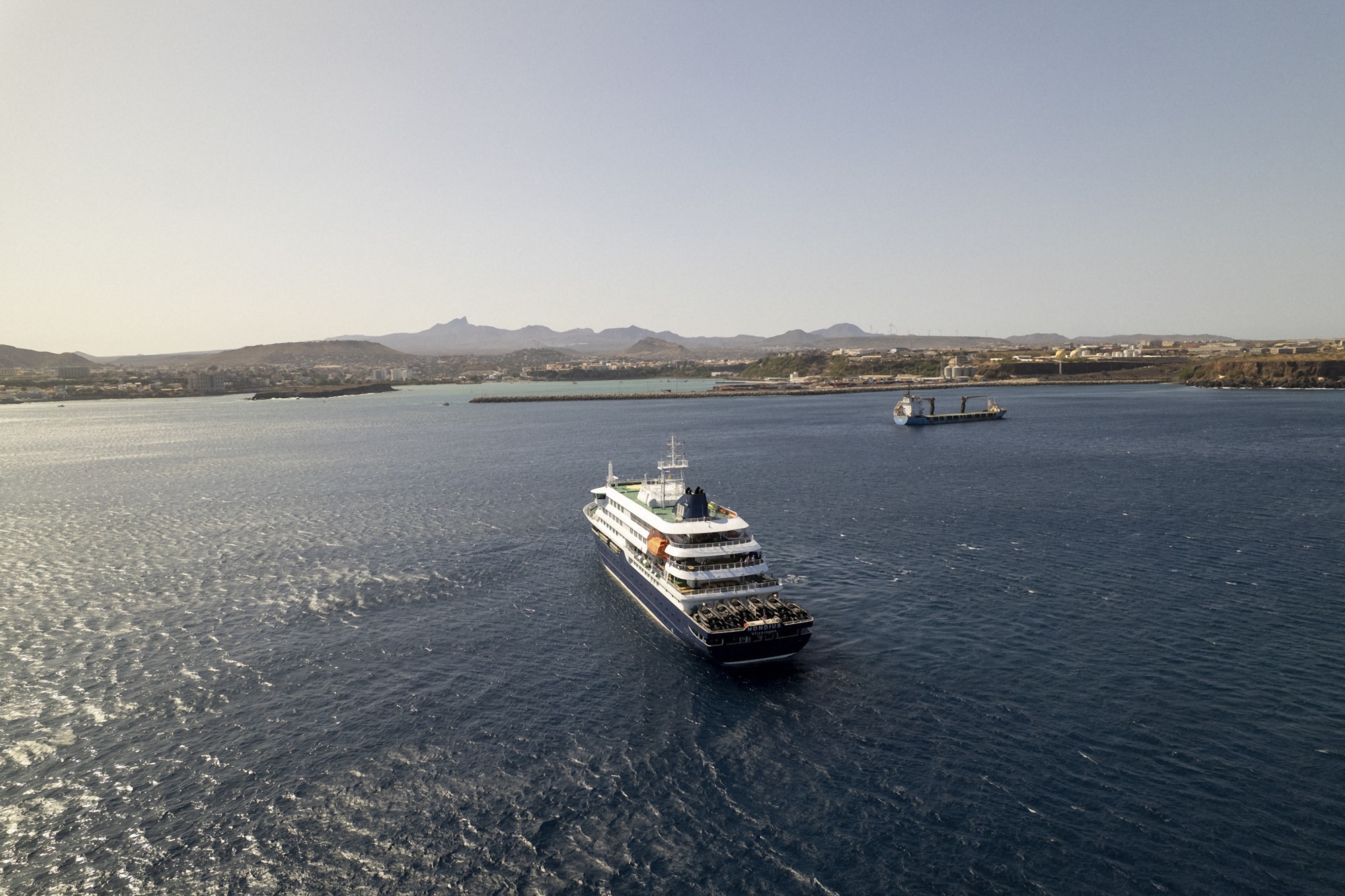 This aerial picture shows a general view of the cruise ship MV Hondius stationary off the port of Praia, the capital of Cape Verde, on May 3, 2026. An outbreak of "severe acute respiratory illness" on board a cruise ship in the Atlantic has left two people dead and a third in intensive care in Johannesburg, South Africa's health ministry told AFP on May 3, 2026. The outbreak occurred on the MV Hondius, travelling from Ushuaia in Argentina to Cape Verde. The patient being treated in Johannesburg tested positive for a hantavirus, a family of viruses that can cause hemorrhagic fever, South African spokesperson Foster Mohale said. (Photo by AFP via Getty Images)