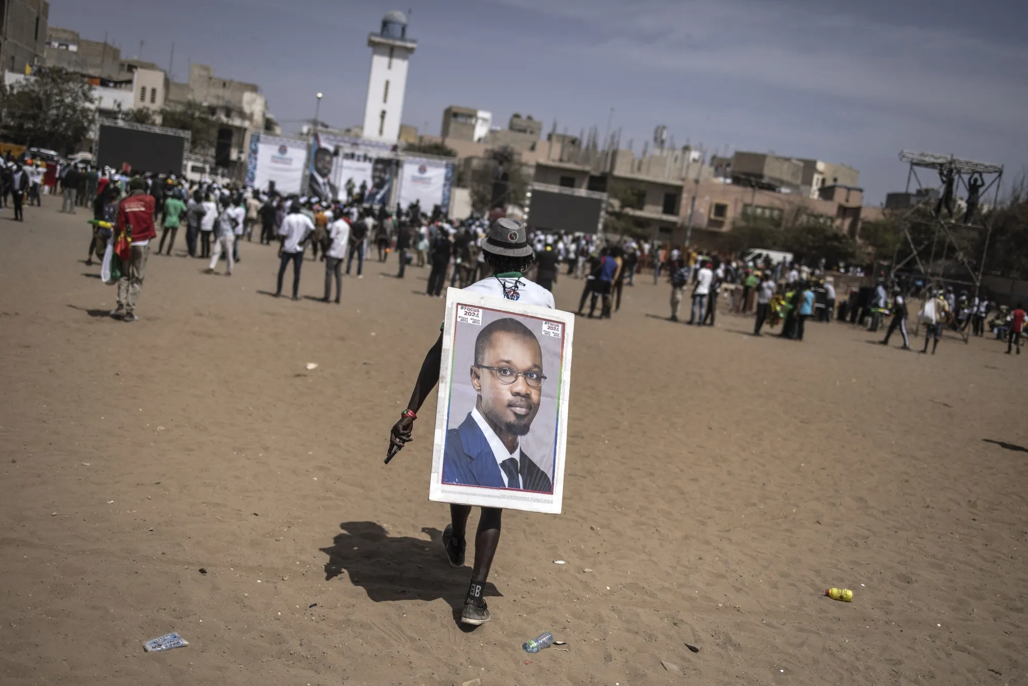 A supporter carries a portrait of Ousmane Sonko in Dakar on March 10.