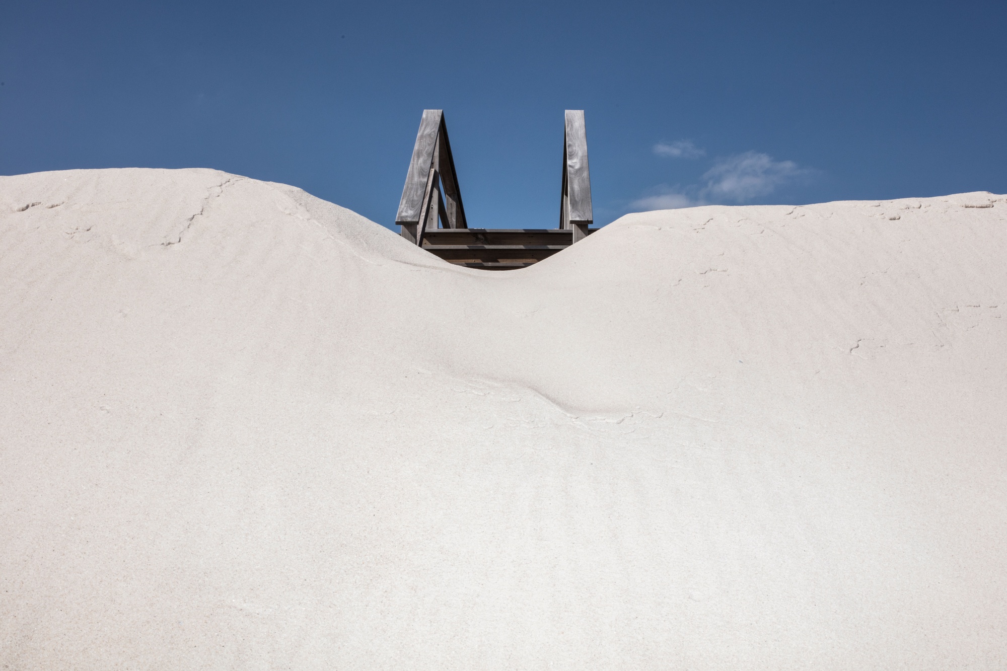 Sand piles up upon a staircase on Dune Road in the Hamptons