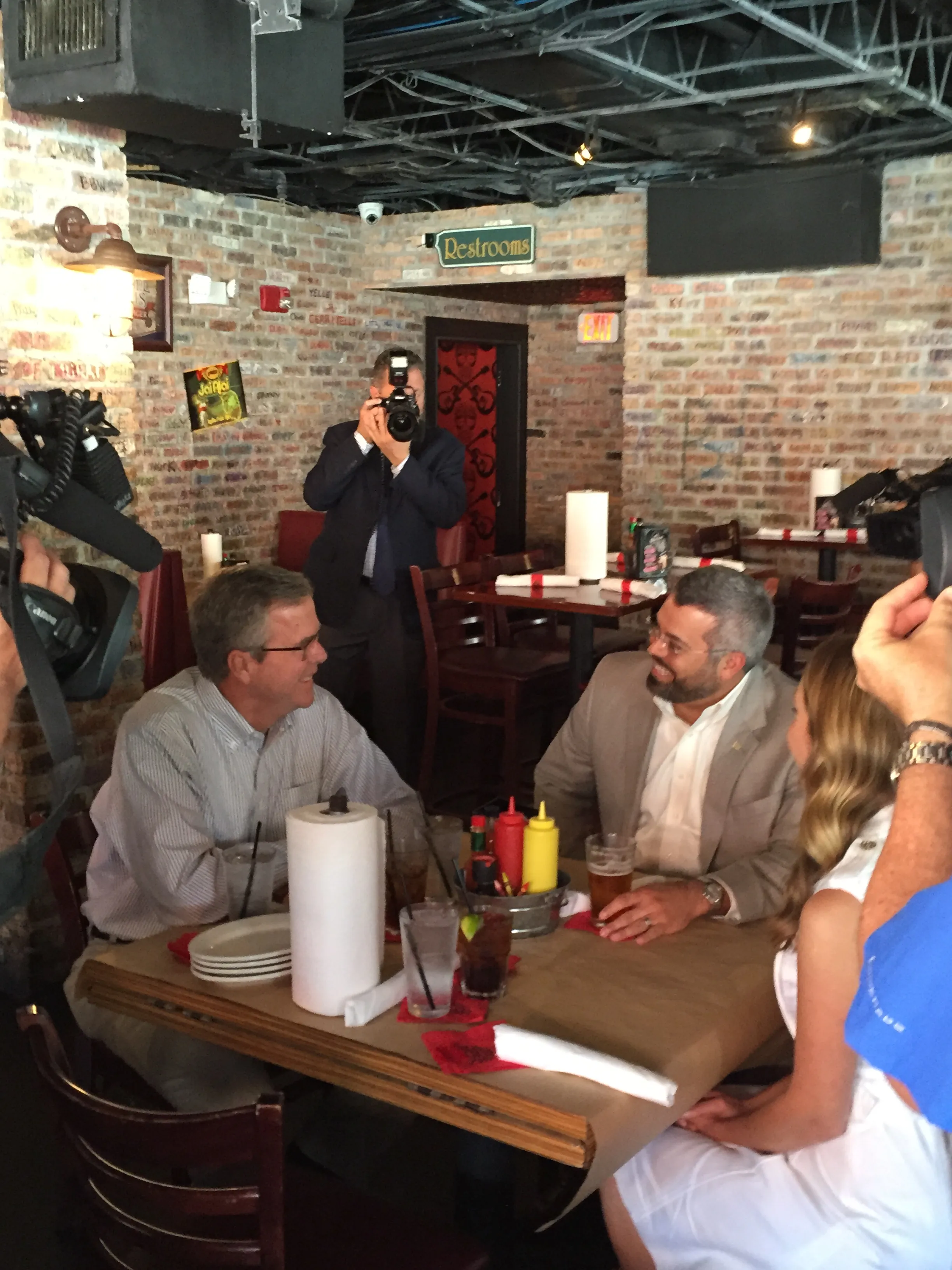 Former Florida Governor Jeb Bush eats lunch with Zeus and Dana Rodriguez, the winners of his political action committee's "Lunch with Jeb" competition.
