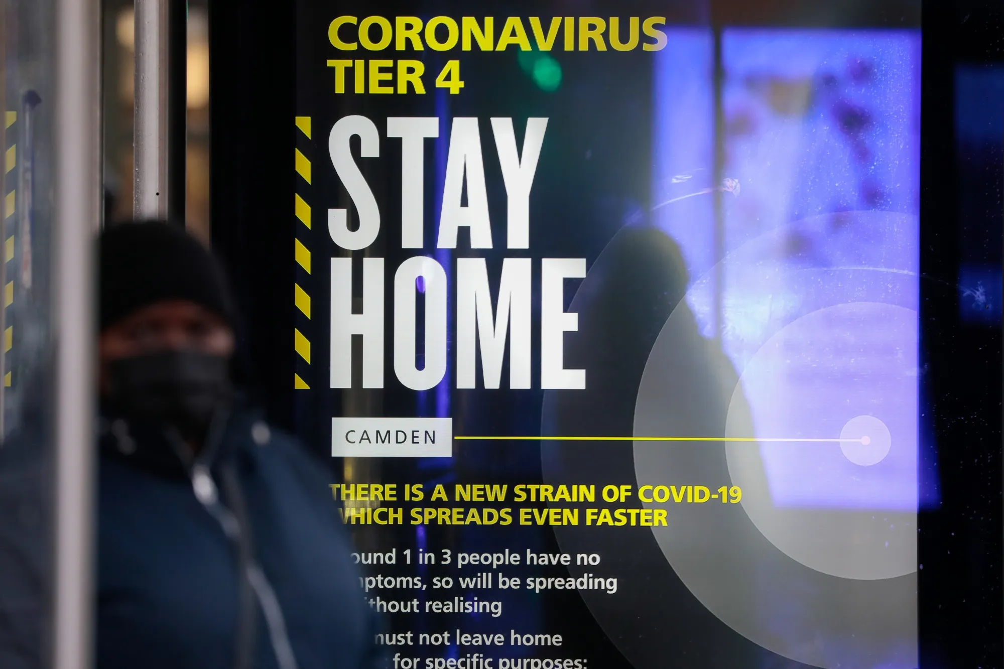 A Coronavirus Tier 4 Stay Home poster near King's Cross railway station in London, U.K., on Monday, Dec. 21, 2020.&nbsp;