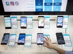 An employee demonstrates an Huawei Technologies Co. Honor 9 inside a Telenor Serbia mobile phone store, operated by Telenor ASA, in Belgrade, Serbia