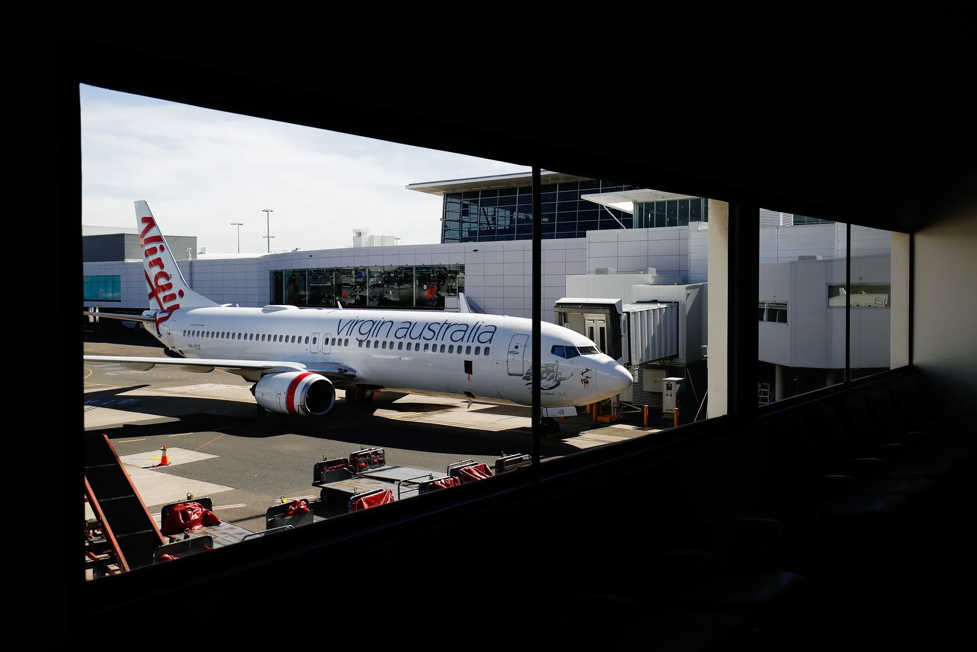 A grounded Virgin aircraft stands on the tarmac at Sydney Airport.