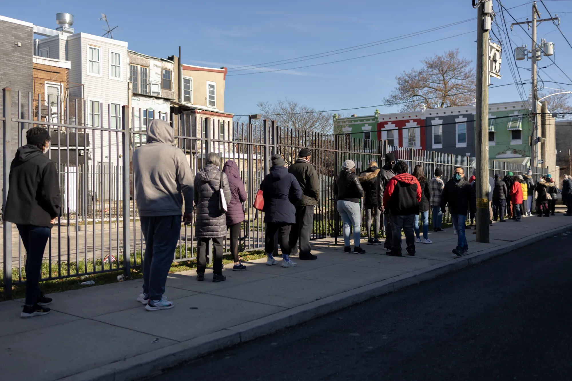 Residents wait in line to receive free rapid at-home Covid-19 test kits at a vaccine clinic in Philadelphia.