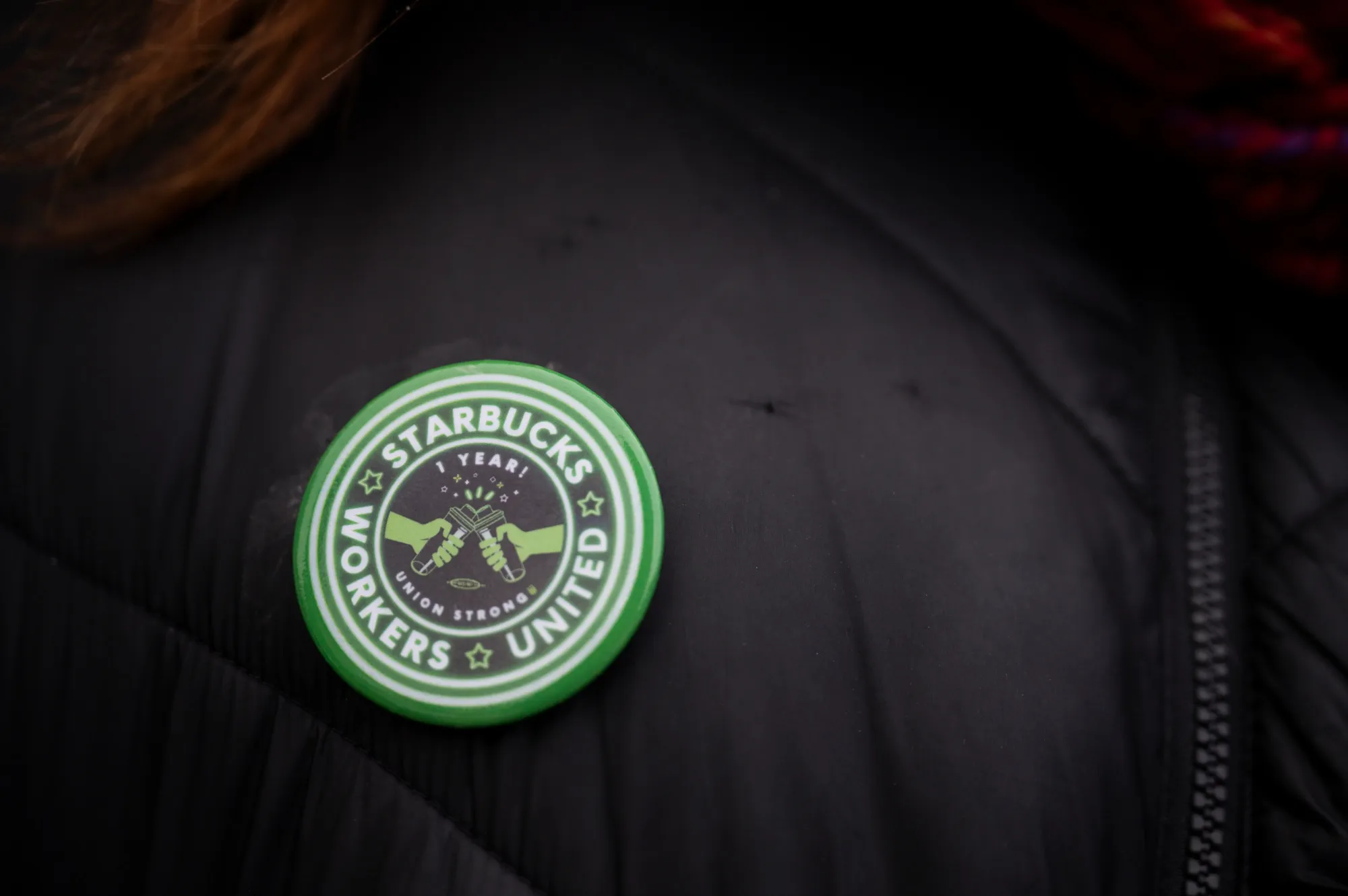 A Starbucks Workers United button.