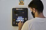 An employee demonstrates a Bitcoin ATM in Palma de Mallorca, Spain.