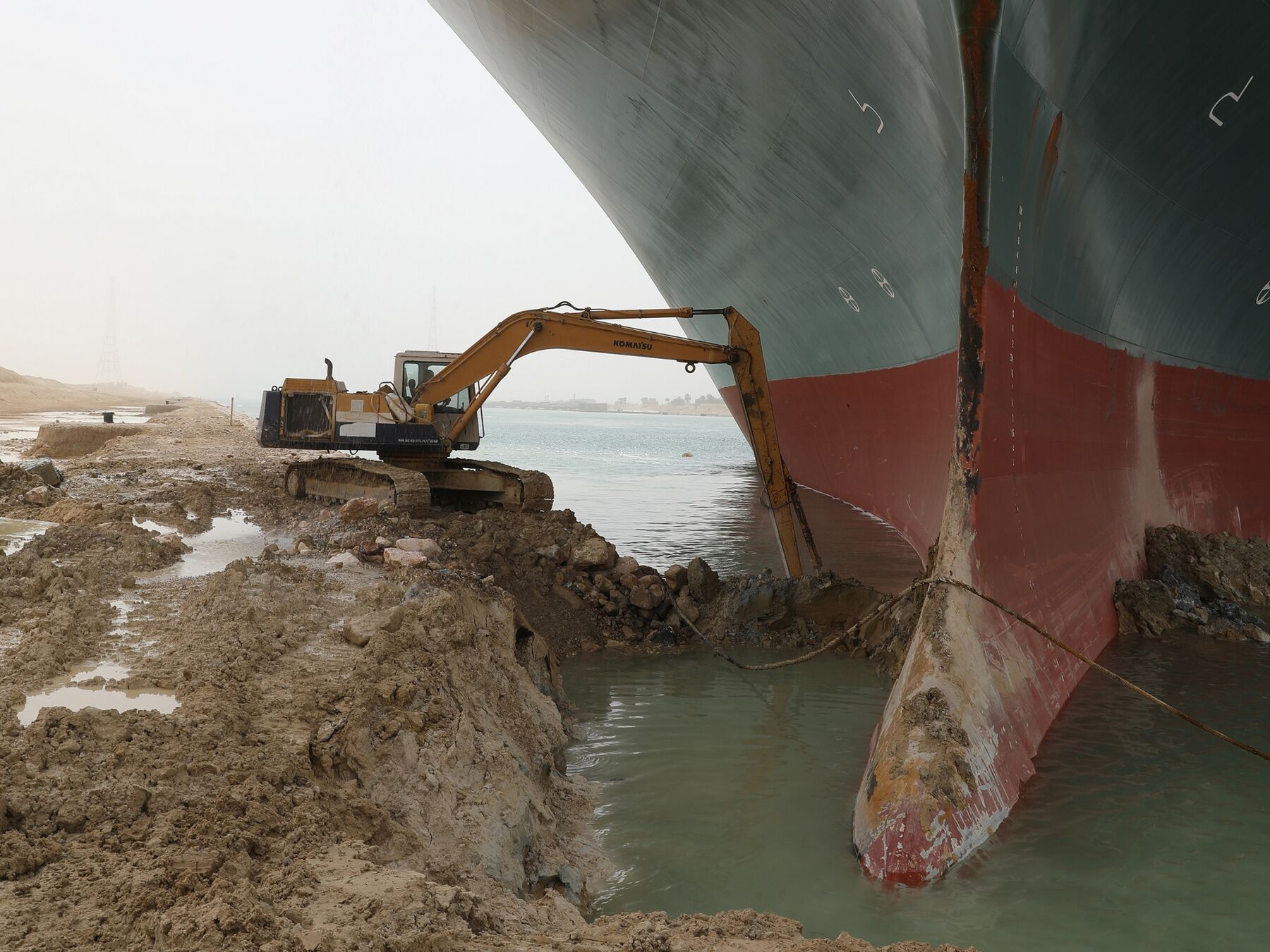 A digger clears the area around the bow of the stuck Ever Given container vessel in the Suez Canal on March 25.