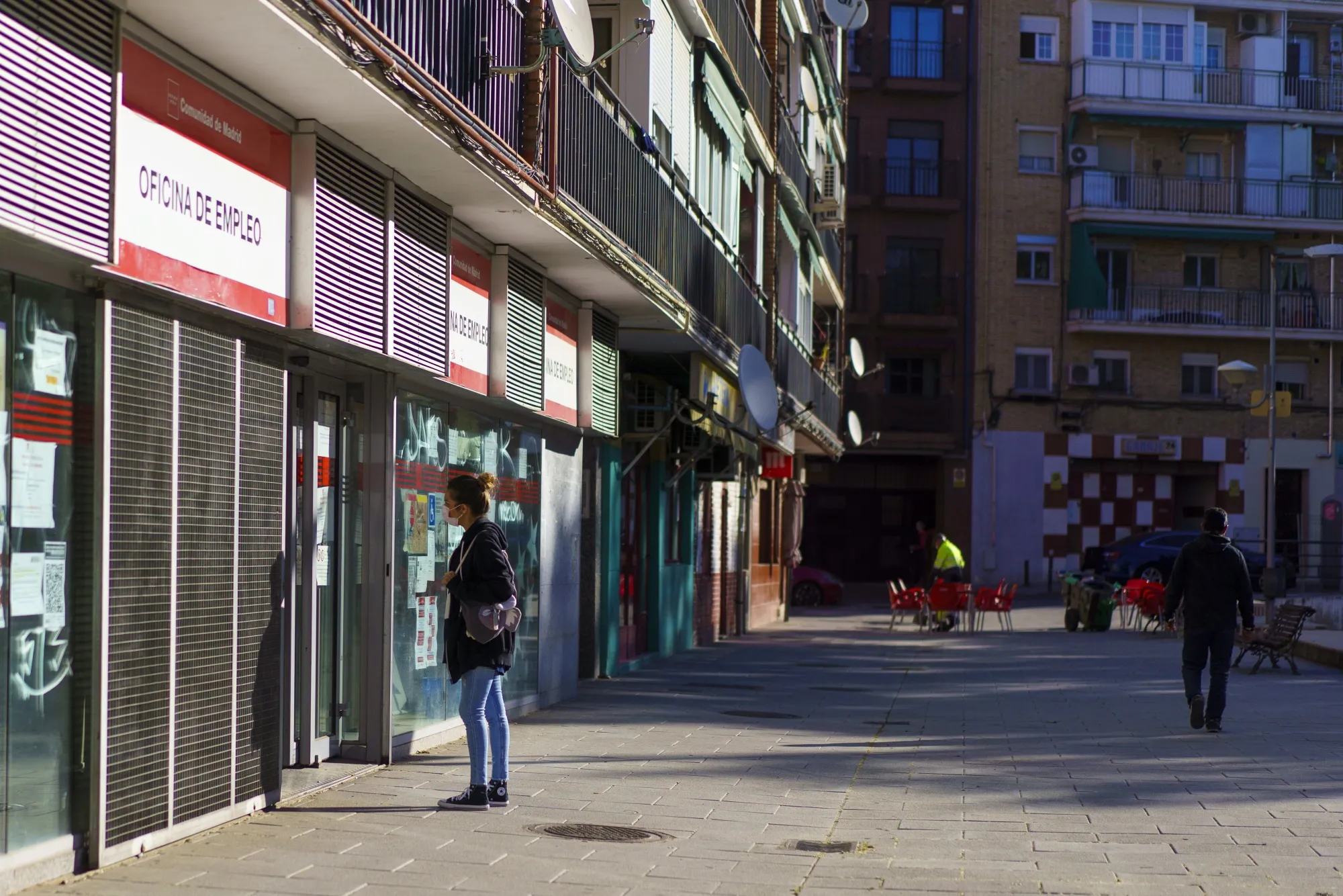 A pedestrian stops to read information in the window of an employment agency office in Alcorcon, near Madrid.