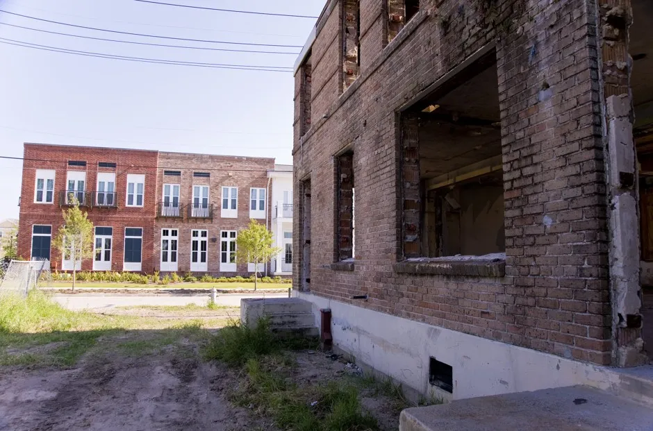 In New Orleans, a contrast between an older housing building, ruined by Hurricane Katrina, and a newer, affordable housing development. 