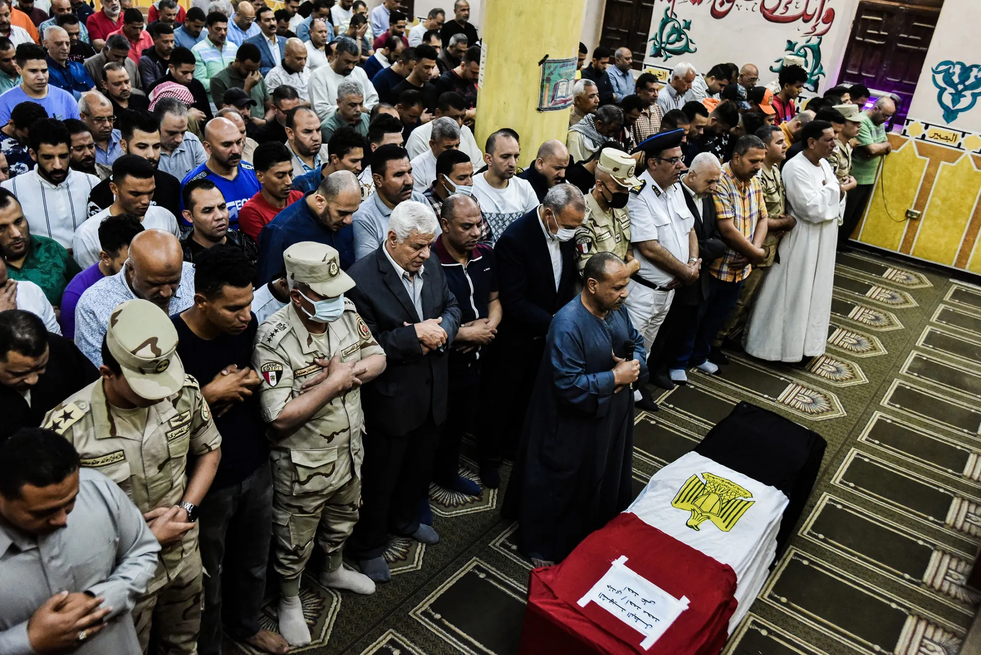 Mourners pray over the body of an Egyptian soldier during his funeral, as his body was returned after he was killed in a terrorist attack near Suez Canal.