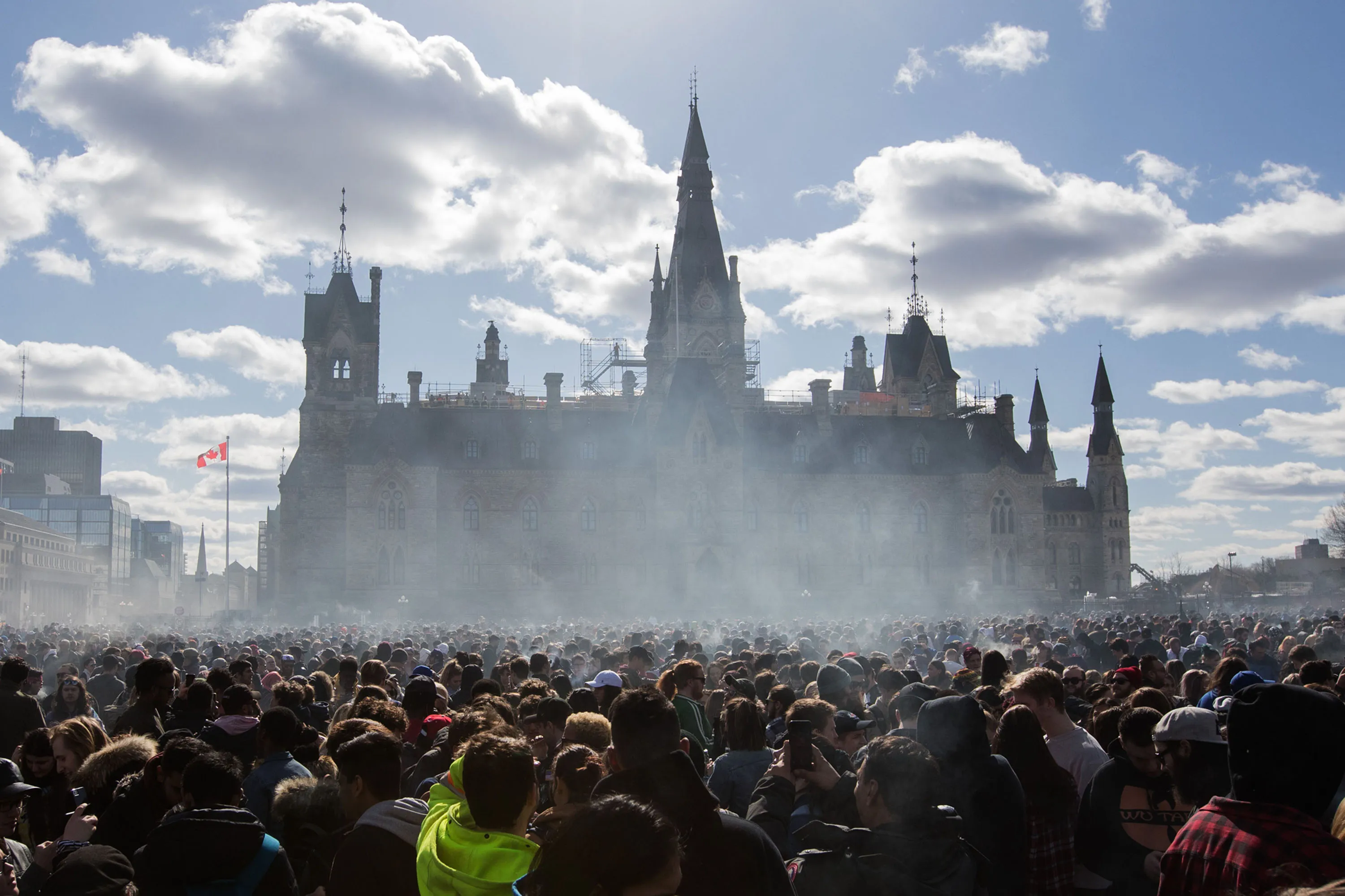 Smoke lingers over Parliament Hill as people smoke marijuana during the annual 4/20 rally in Ottawa,&nbsp;April 20, 2018.
