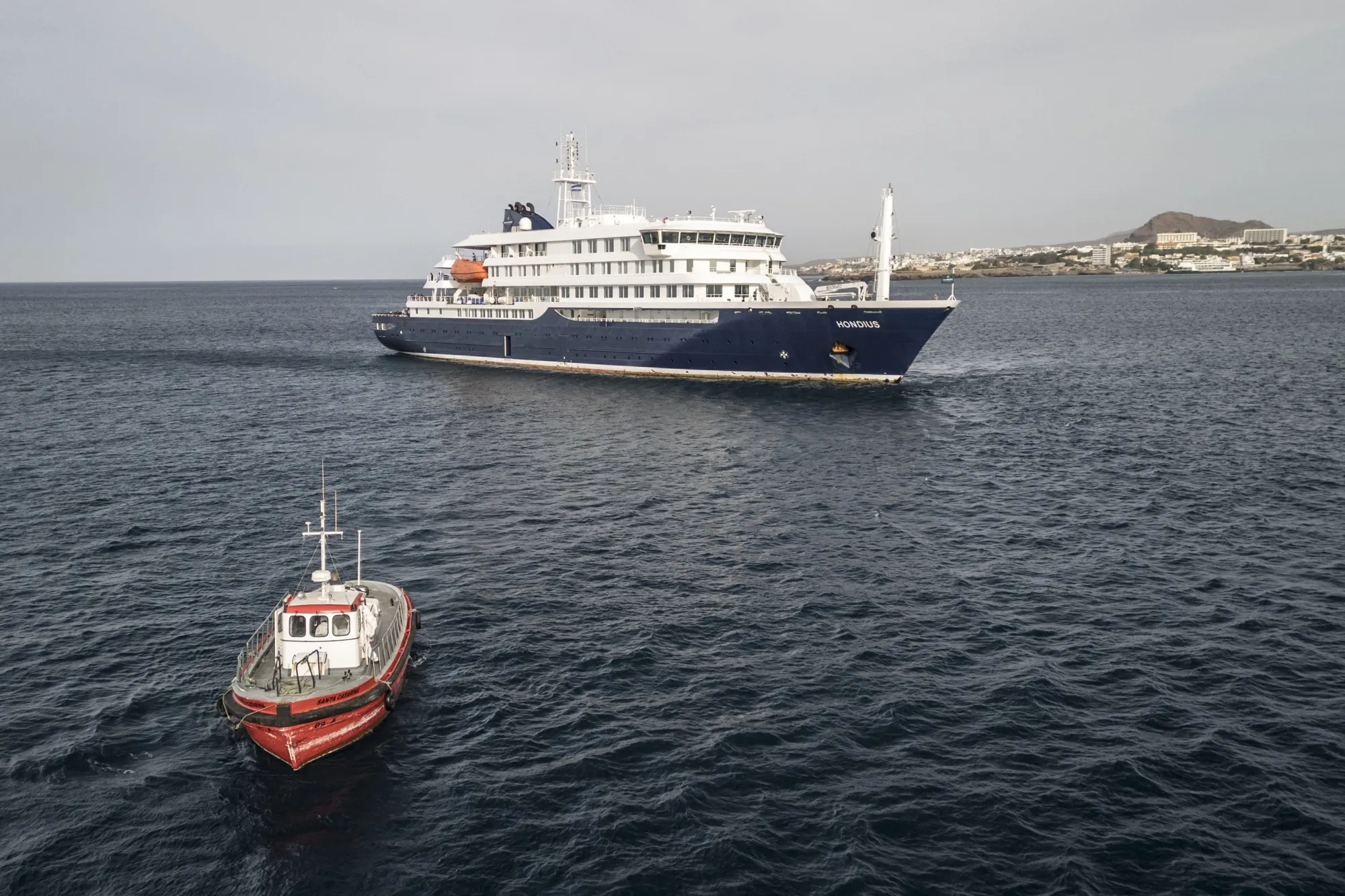 A boat heads toward shore from the cruise ship MV Hondius off the port of Praia, Cape Verde.