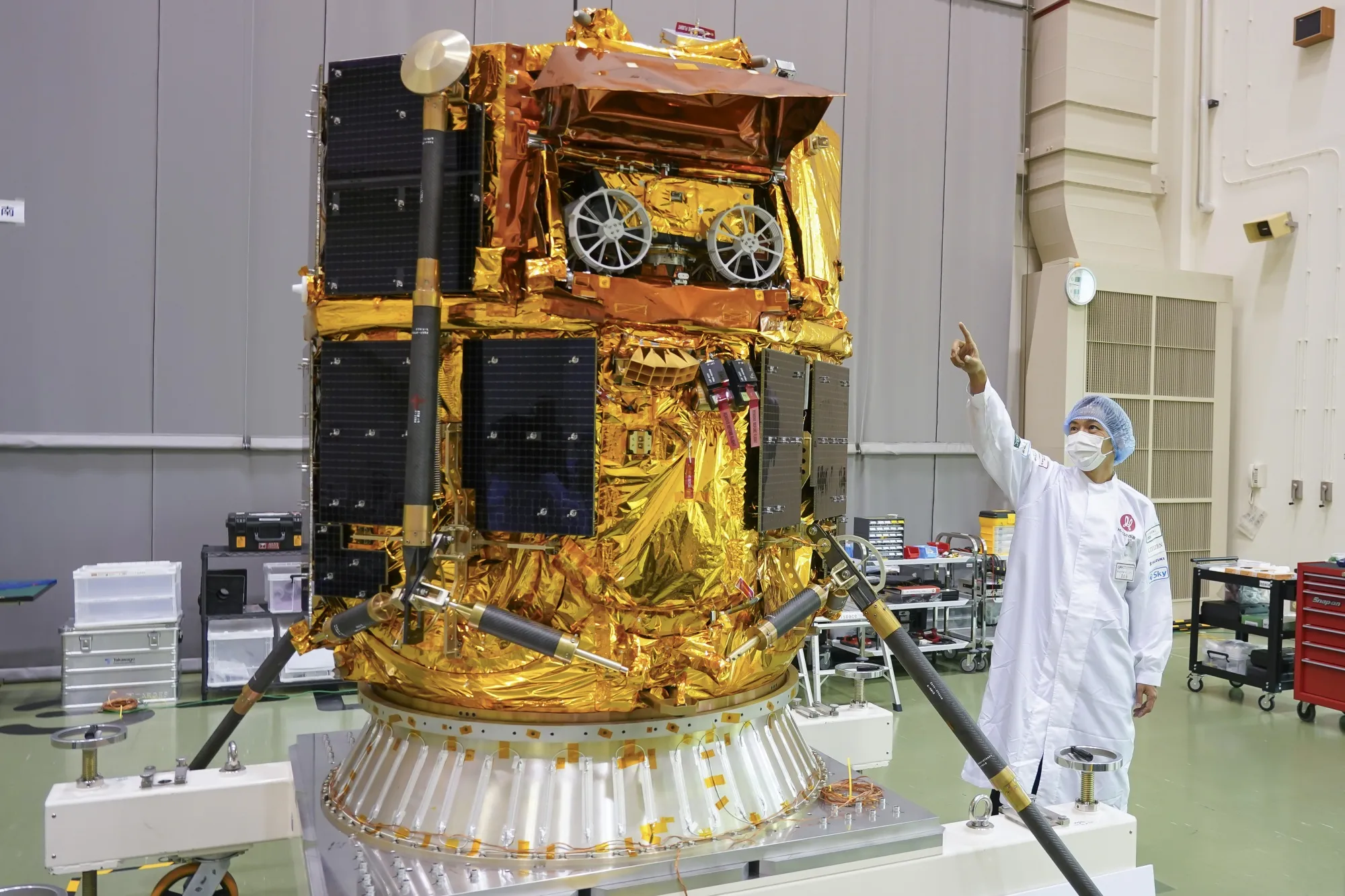 Ryo Ujiie, chief technology officer of ispace, points at a&nbsp;rover to be carried by the company’s lunar lander at the Japan Aerospace Exploration Agency Tsukuba Space Center in September&nbsp;2024.&nbsp;