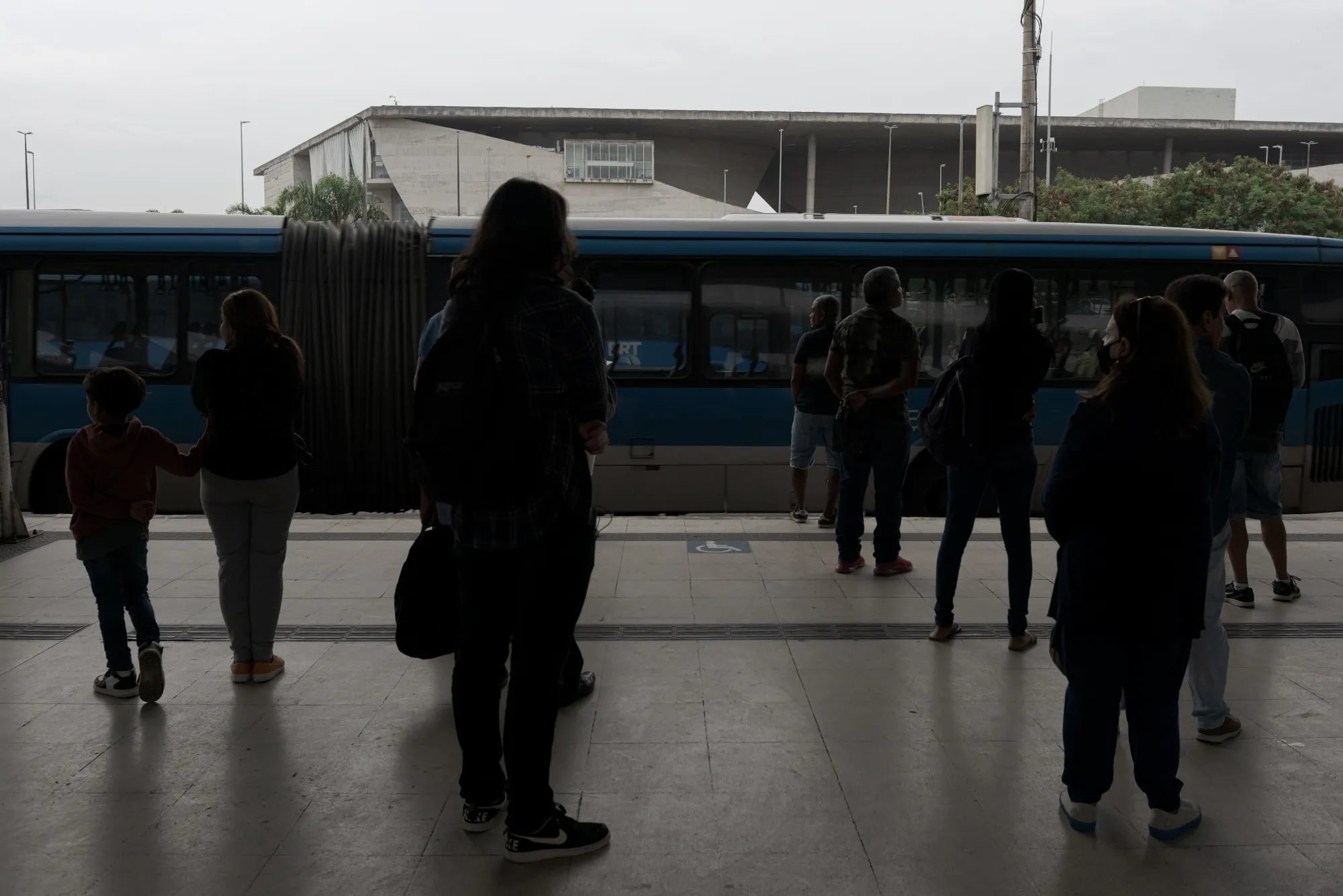 Commuters wait for a bus at the Bus Rapid Transport (BRT) Alvorada Terminal in Rio de Janeiro.
