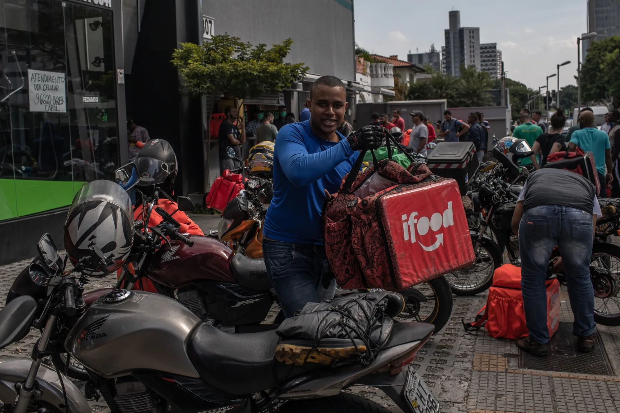A worker carries an insulated backpack before making an iFood app delivery in Sao Paulo, Brazil, on&nbsp;April 1.