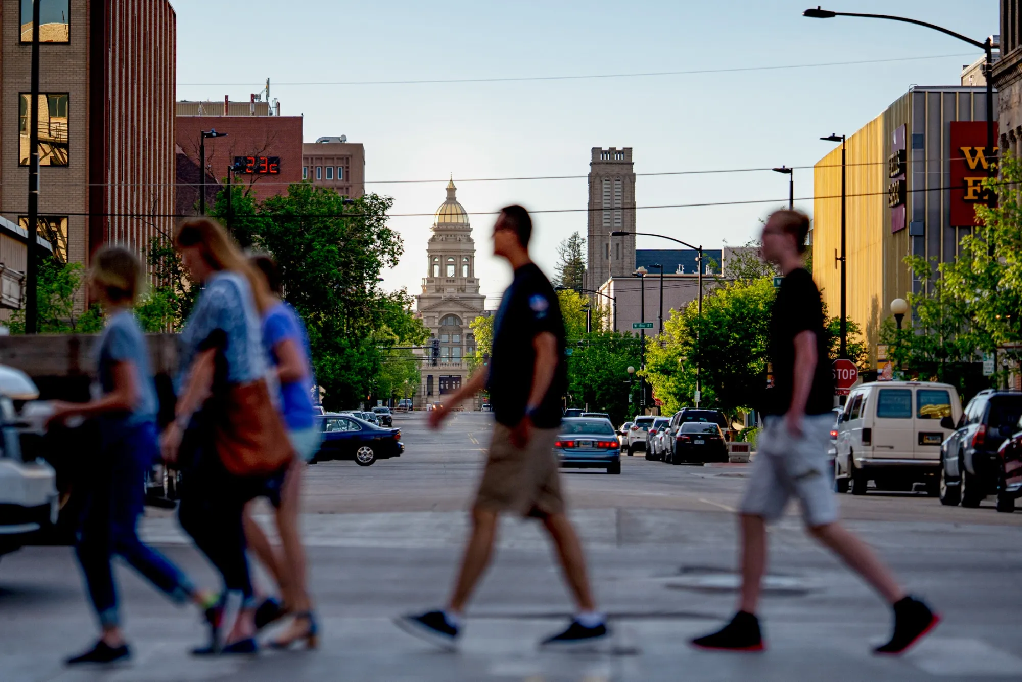 Pedestrians cross the street near the Wyoming State Capitol in downtown Cheyenne.