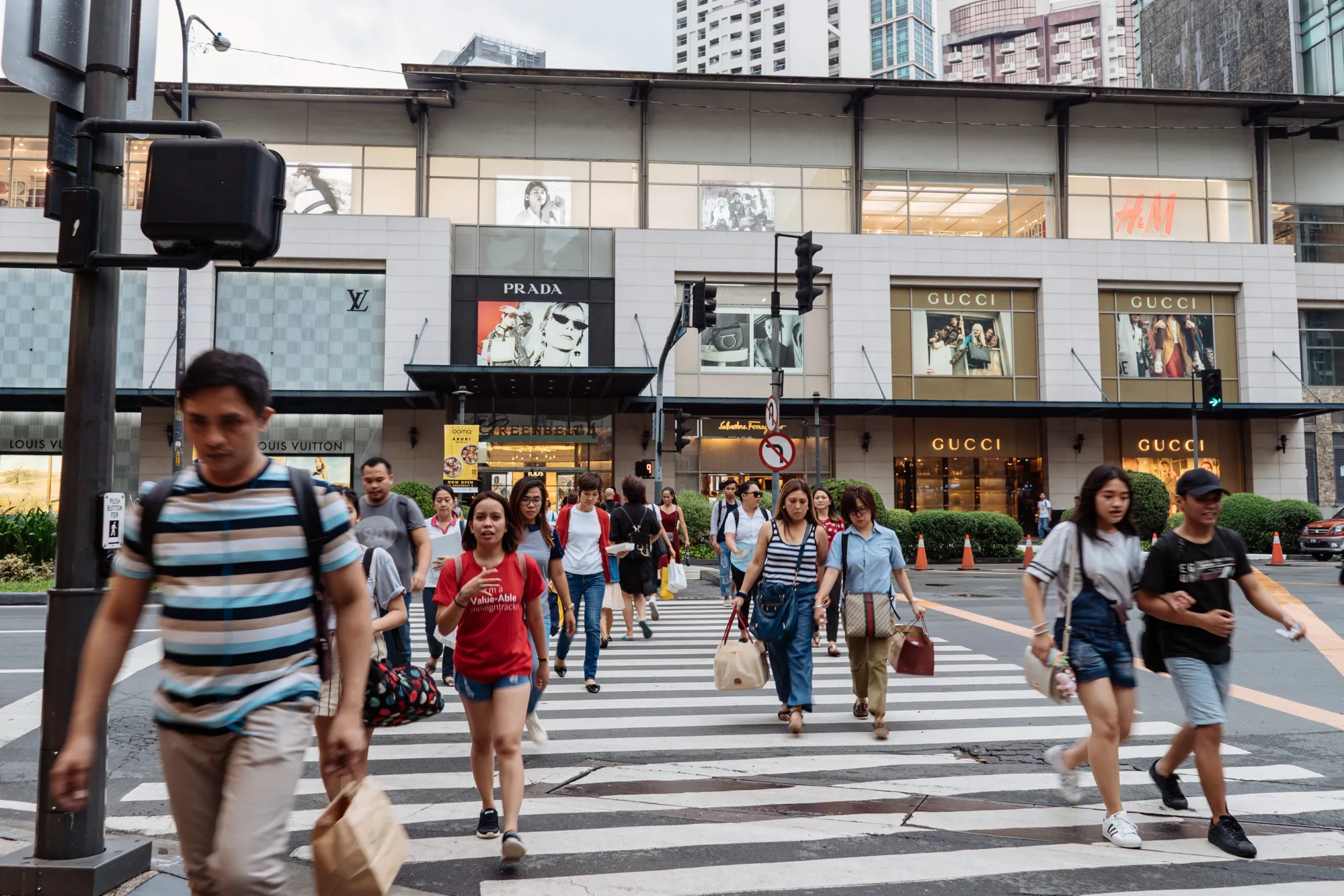 Pedestrians cross a road in Manila, the Philippines.