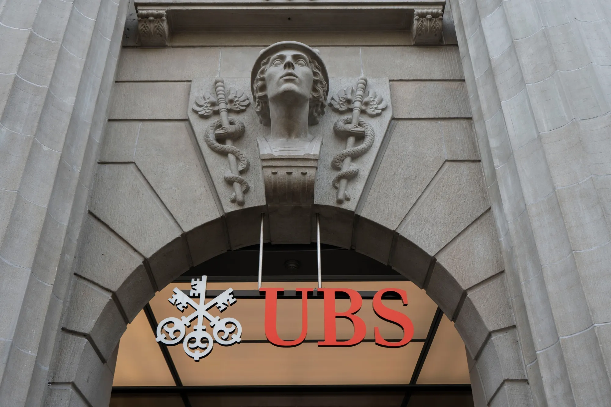 A sign above the entrance to the UBS Group AG headquarters in Zurich, Switzerland.