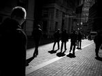 Pedestrians walk past the New York Stock Exchange.