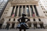 The New York Stock Exchange (NYSE) at Wall Street and the 'Fearless Girl' statue are seen on March 23, 2021 in New York City. - Wall Street stocks were under pressure early ahead of congressional testimony from Federal Reserve Chief Jerome Powell as US Treasury bond yields continued to retreat. (Photo by Angela Weiss / AFP) (Photo by ANGELA WEISS/AFP via Getty Images)