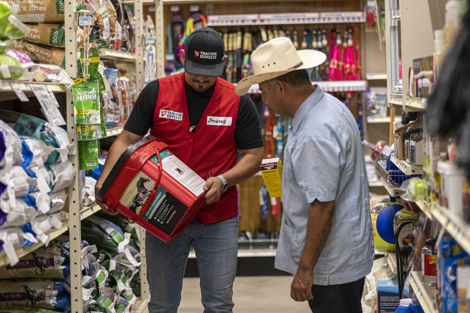 A worker assists a customer at a Tractor Supply Co. store in Merced, California.