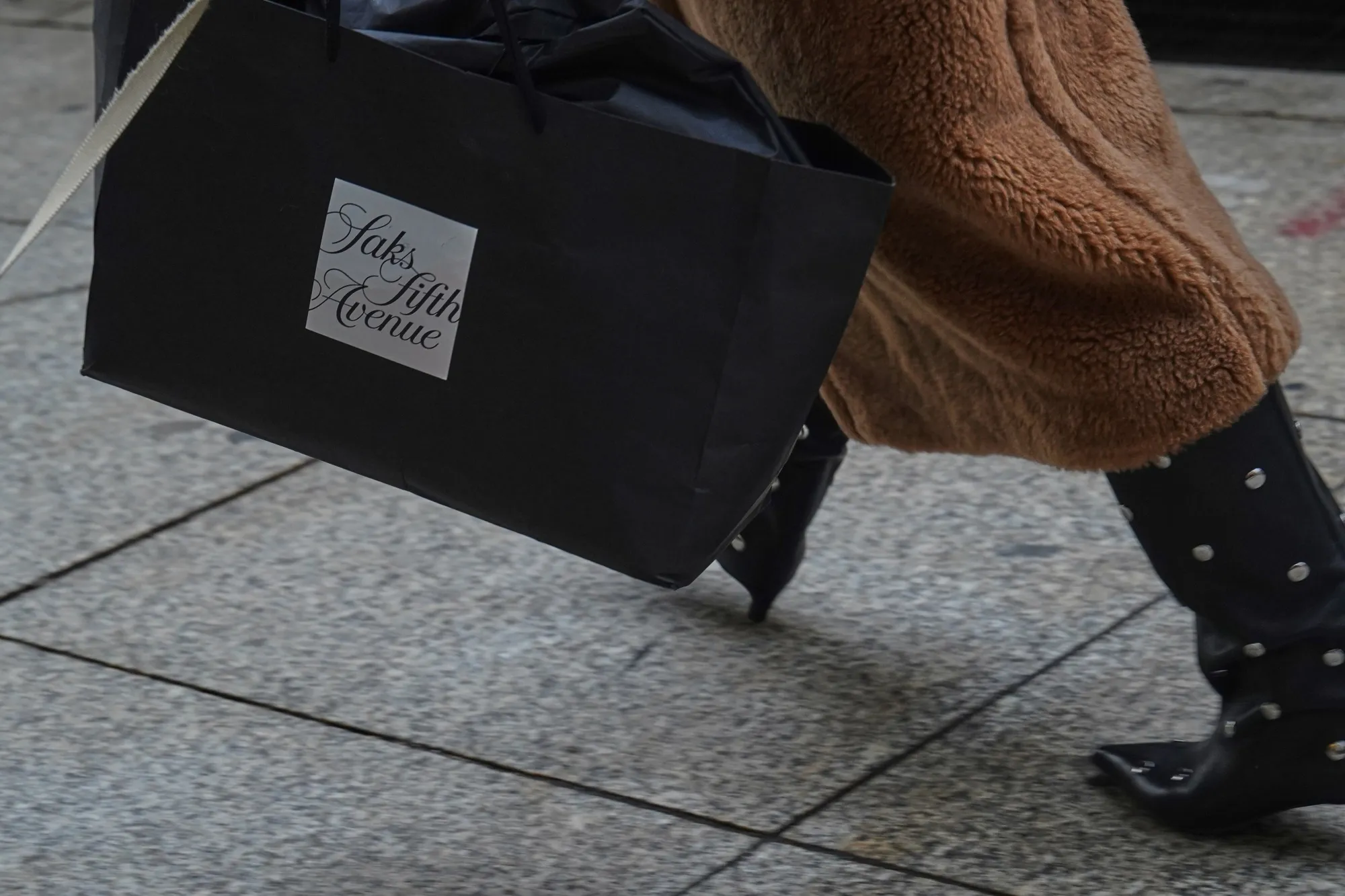 A shopper carries a Saks Fifth Avenue shopping bag in New York.