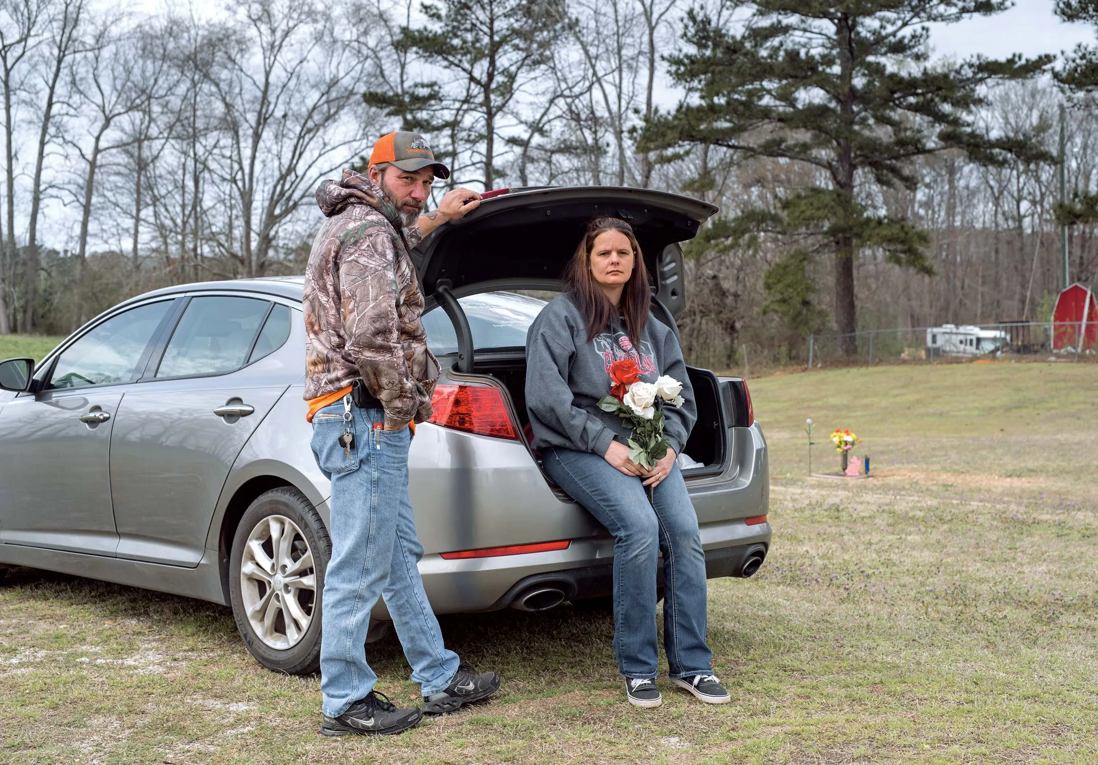Angel Ogle and her husband, Robbie Ogle, at the grave of Angel’s daughter, Regina Elsea.
