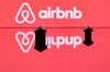 This illustration picture taken in Paris on August 29, 2018, shows toy houses next to the logo of rental website Airbnb.