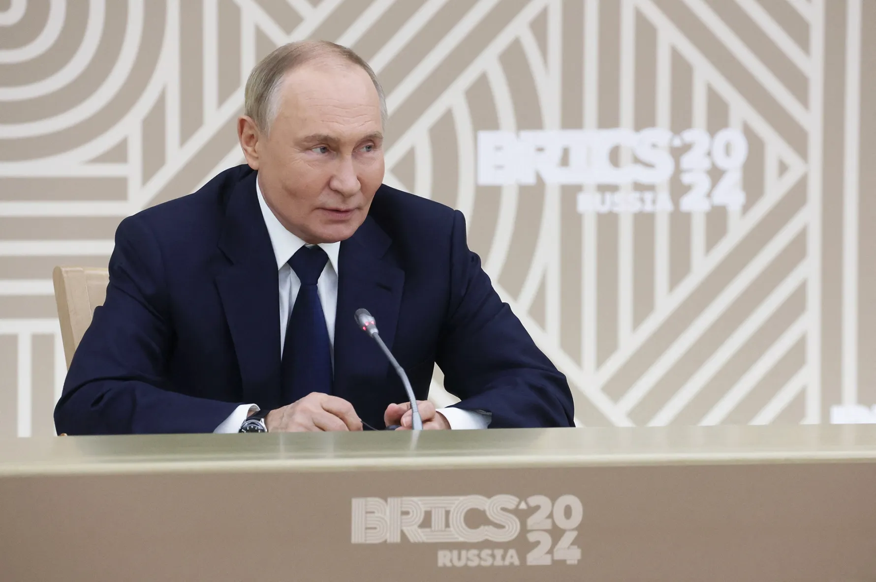 In this pool photograph distributed by the Russian state agency Sputnik, Vladimir Putin meets with the heads of media outlets from BRICS member countries in Moscow, on Oct.&nbsp;18.