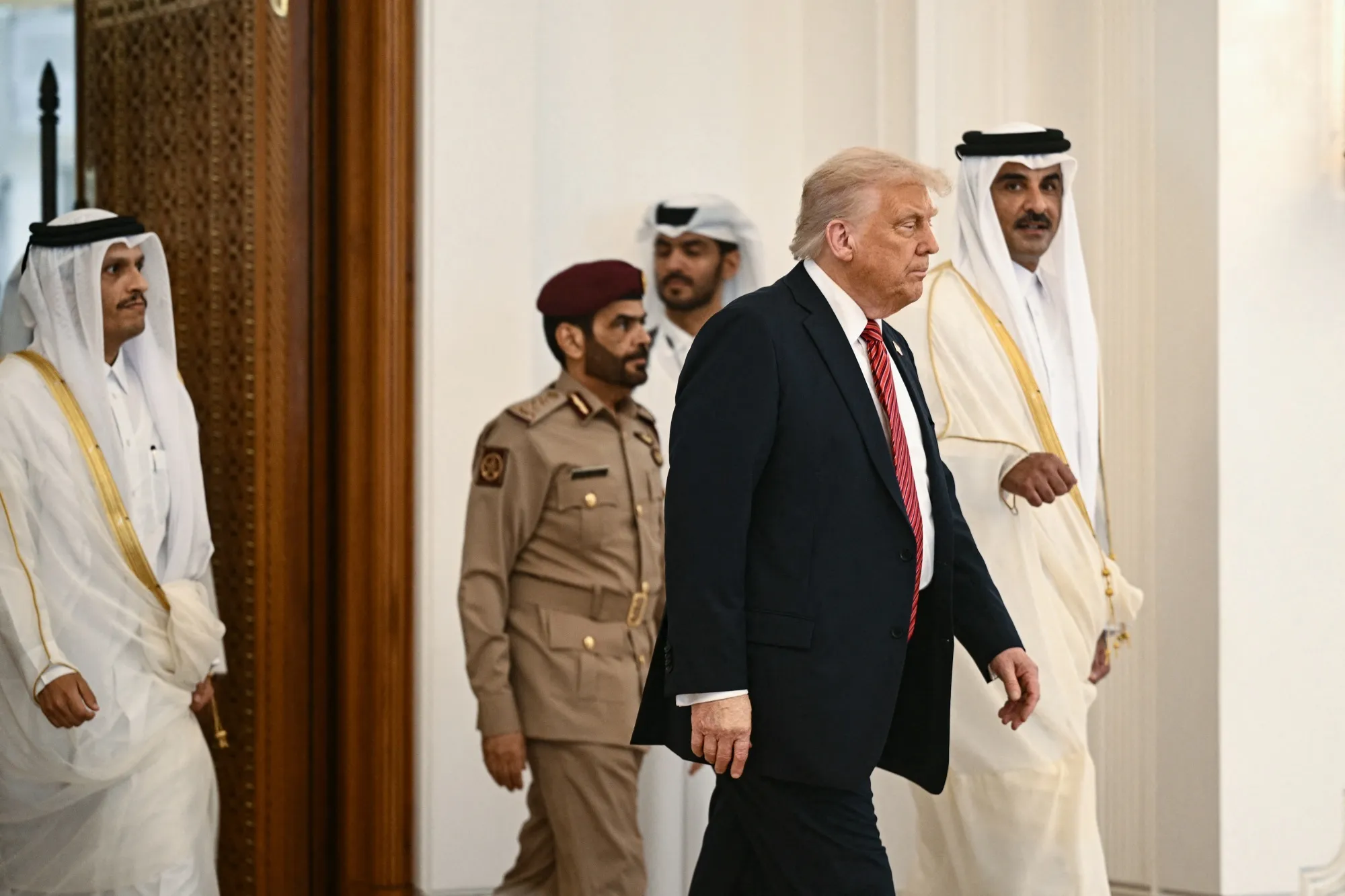 Qatar's Emir Sheikh Tamim bin Hamad al-Thani and President Donald Trump arrive at the Royal Palace in Doha&nbsp;on May 14.
