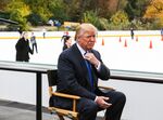 Donald Trump adjusts his tie before an interview at Wollman Rink in Central Park in New York, in 2015.