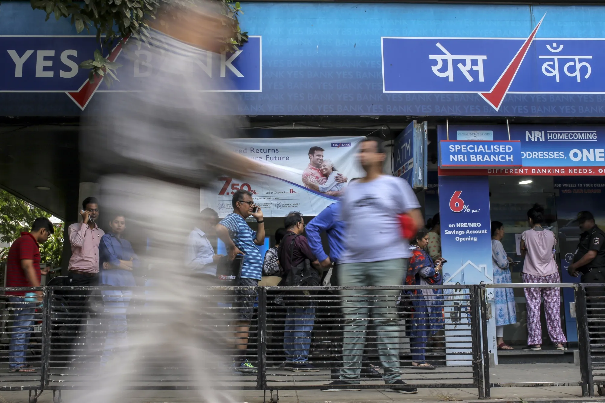 Customers stand in line outside a Yes Bank Ltd. branch in Mumbai, India, on Friday, March 6.&nbsp;