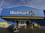 A worker pulls shopping carts outside a Walmart store in Montreal, Quebec, on Jan. 24, 2022.&nbsp;