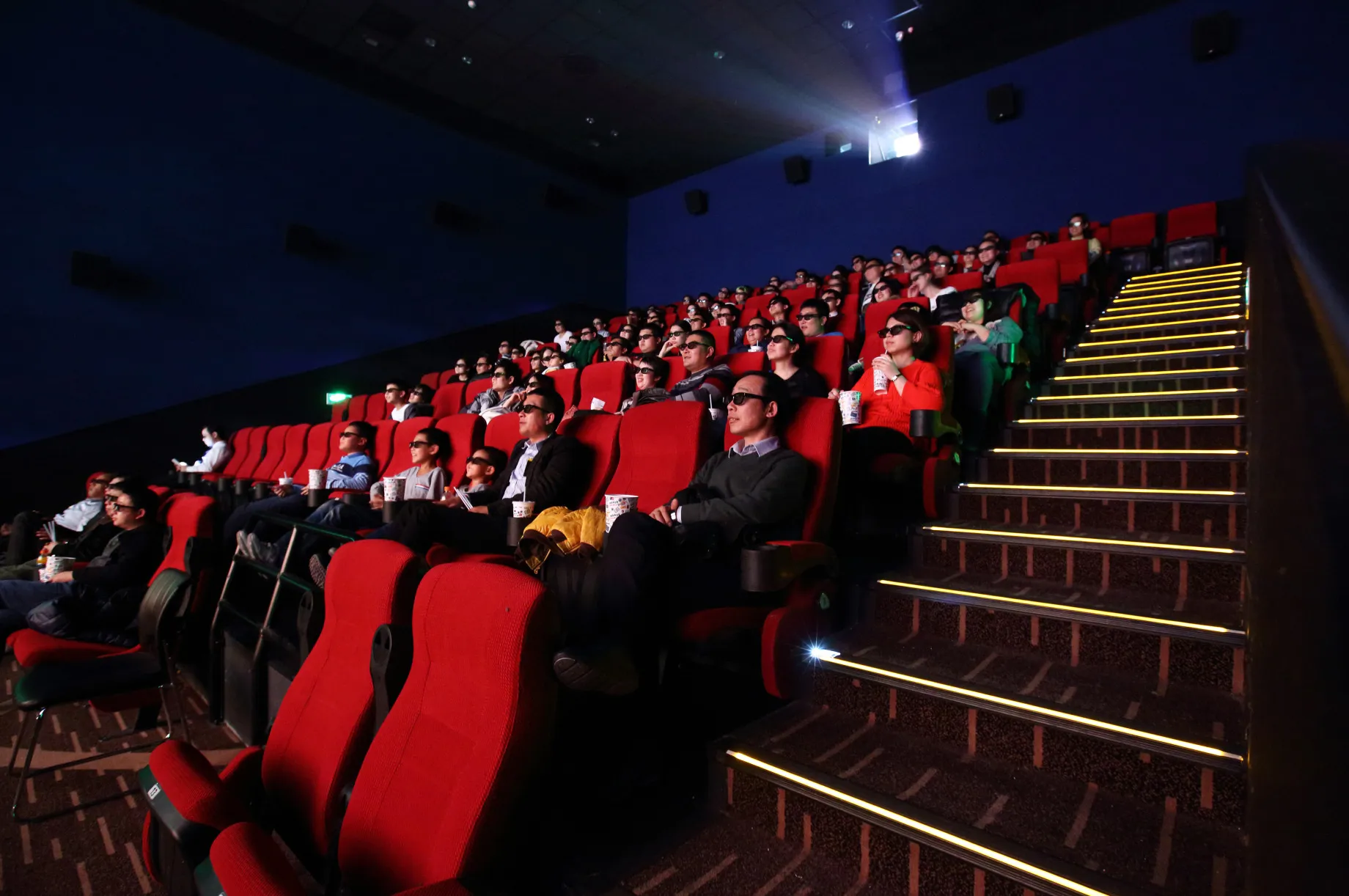 People wear 3-D glasses while watch a movie in the Wanda Cinema Line Co. cinema at the Tongzhou Wanda Plaza shopping mall, operated by Dalian Wanda Group Co., in Beijing, China, on Saturday, March 14, 2015. Dalian Wanda is controlled by Chinese billionaire Wang Jianlin.