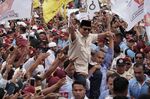 Prabowo Subianto, presidential candidate, greets supporters while being carried during a campaign rally in Bogor, West Java, Indonesia, on March 29, 2019.