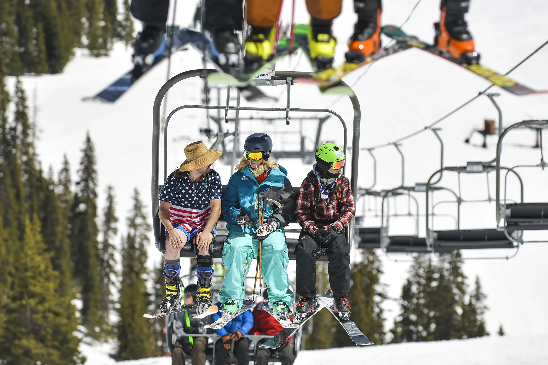 A skier wearing shorts and a t-shirt rides the chair lift at Arapahoe Basin Ski Area on May 25, 2019 in Dillon, Colorado.