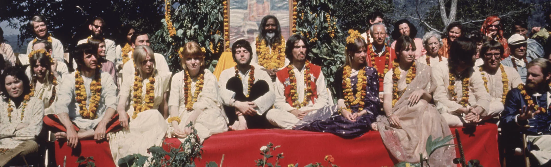 The Beatles and their wives in Rishikesh,&nbsp;India, with Maharishi Mahesh Yogi, March 1968. The group includes Ringo Starr, Maureen Starkey, Jane Asher, Paul McCartney, George Harrison, Patti Boyd, Cynthia Lennon, John Lennon, Beatles roadie Mal Evans, Prudence Farrow, Jenny Boyd, and Beach Boy Mike Love.