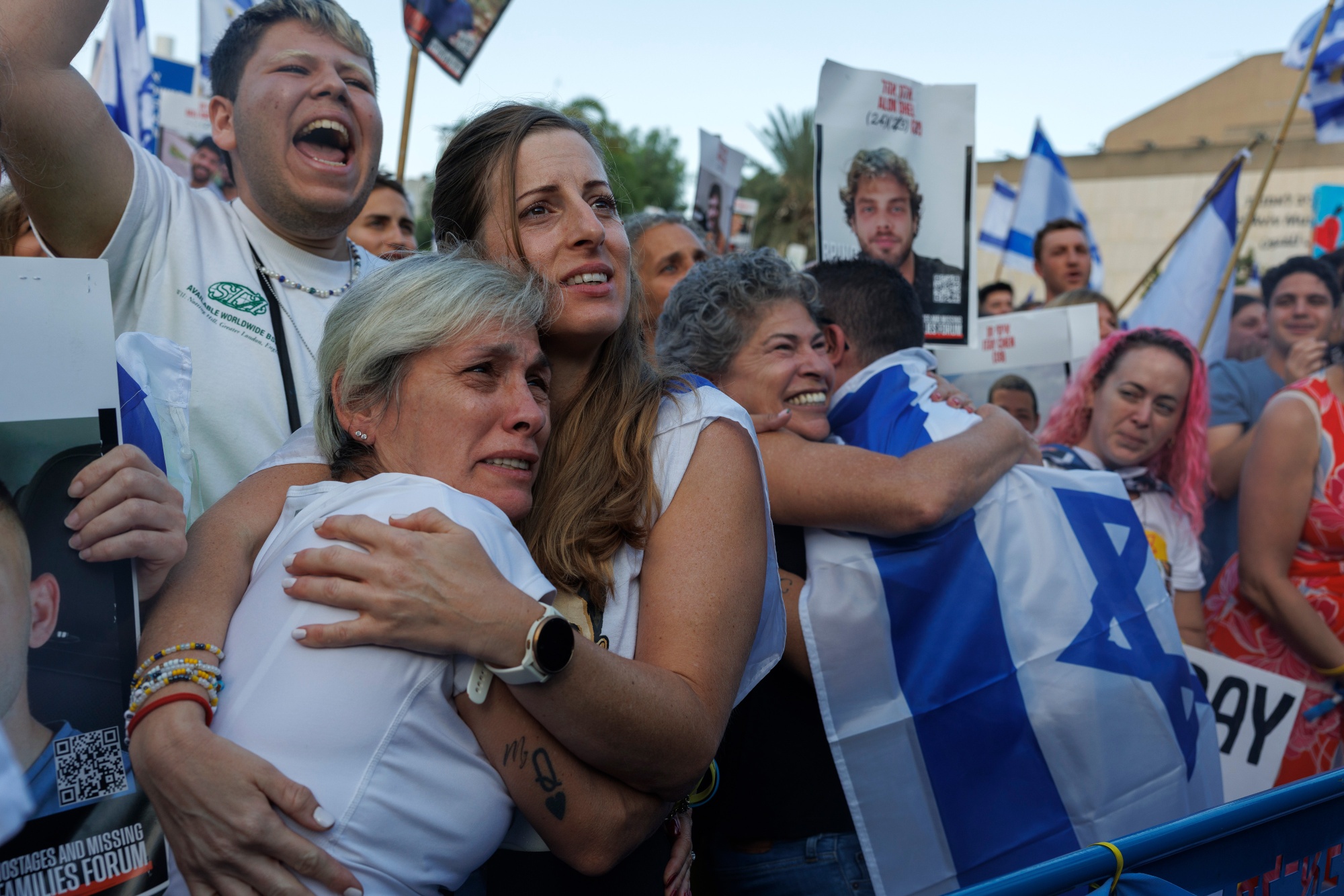 Israelis react as they watch the release of Israeli hostages by Hamas during a live broadcast on so-called hostages square in Tel Aviv, Israel, on Monday, Oct. 13, 2025. Hamas freed seven living Israeli hostages from the Gaza Strip on Monday morning, following a US-led deal reached late last week. Photographer: Kobi Wolf&#x2F;Bloomberg