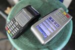 Electronic payment terminals sit on a stool at a gas station in Bengaluru, India, on Saturday, Feb. 4, 2017.