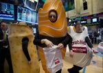 Actors dressed in Grubhub Inc. costumes interact with traders on the floor of the New York Stock Exchange in New York, U.S., on Friday, April 4, 2014.
