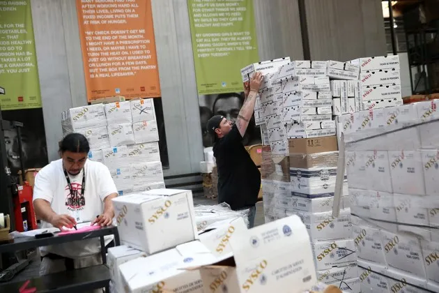 Workers stack boxes of donated produce at the SF-Marin Food Bank on May 1, 2014 in San Francisco