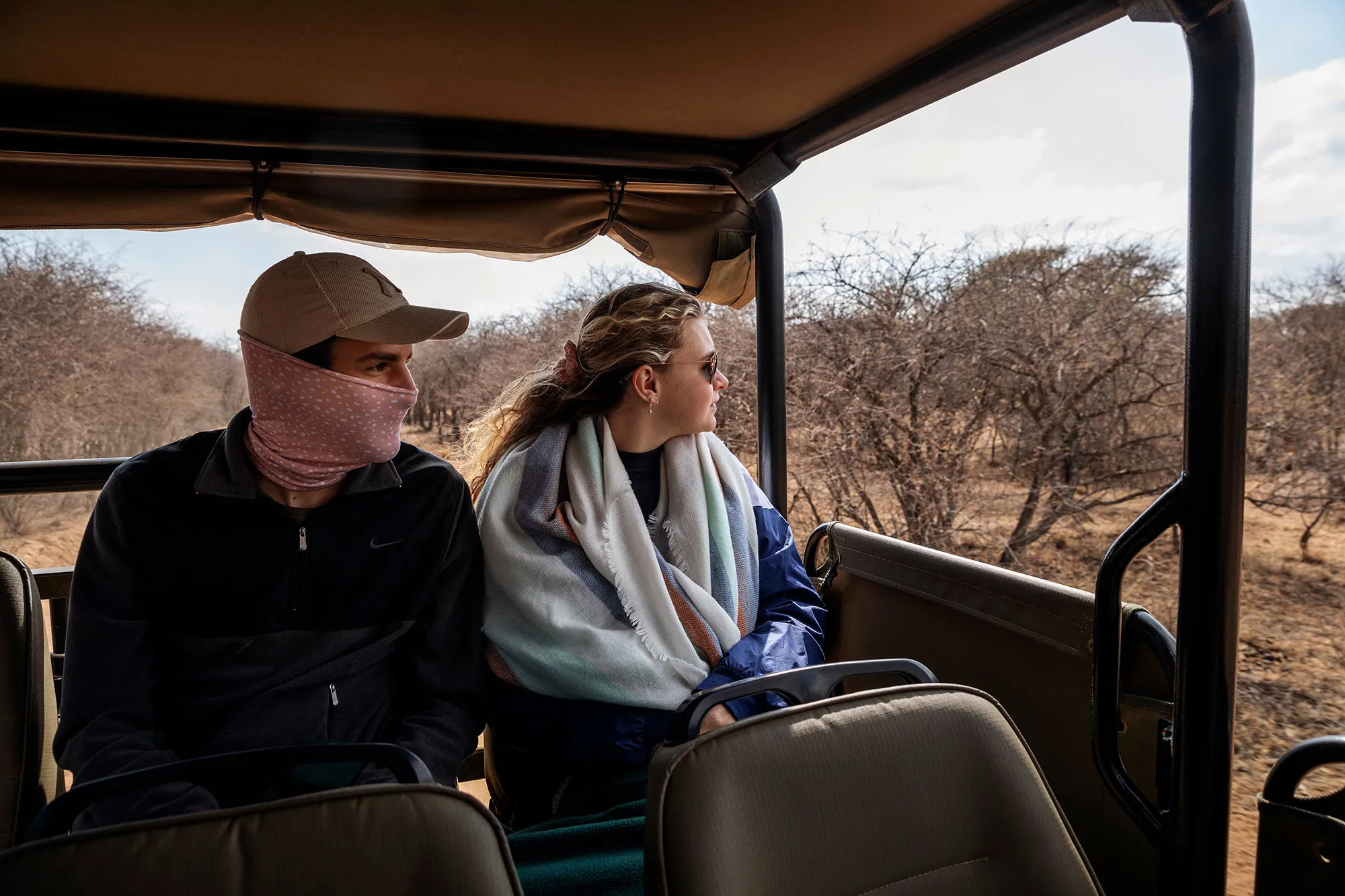 A couple of tourists scouts for animals during a guided safari tour in Pretoria, on Aug. 7.