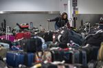 A traveler looks for luggage in the Southwest Airlines baggage claim area at Oakland International Airport in California, on Dec. 28, 2022.