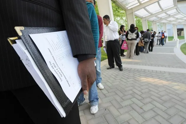 Job applicants waiting in line to speak with recruiters during a job fair in College Park, Ga., in 2012
