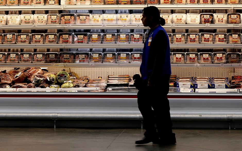 A worker stands in a Sam's Club during a 2014 media tour of Walmart Stores Inc.'s annual shareholder meeting.